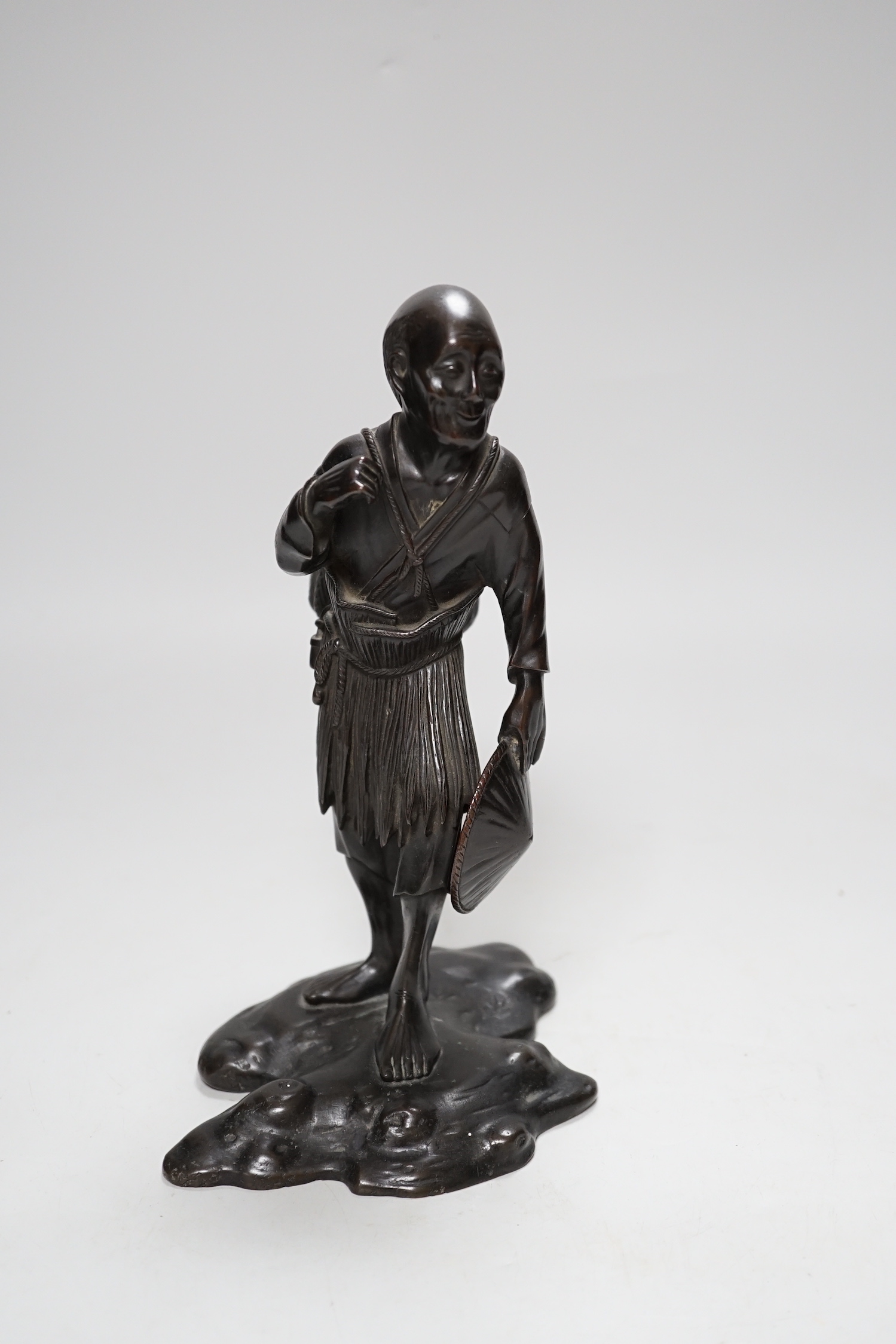 A Japanese bronze figure of an elder, 19th century, 23cm high